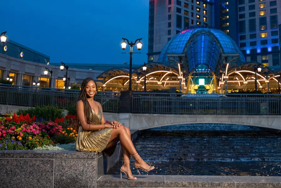 A woman by the water outside Fallsview at dusk